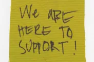 Piece of cloth with "We are here to support!"