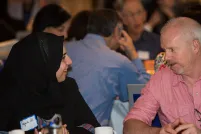 Two people talking at a table.