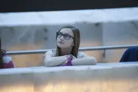  Three young people leaning on a glowing alabaster ramp and looking up.