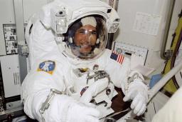 A smiling man in an astronaut suit.