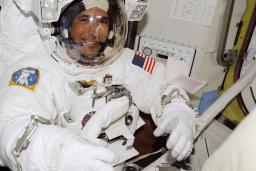 A smiling man in an astronaut suit.