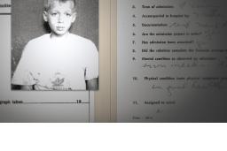 A black-and-white photo of a sad-looking boy is paperclipped to an institution admission form that asks his name, when he was admitted, and his mental condition.