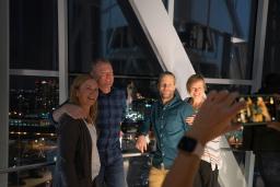 Two smiling couples standing together and posing for a photo in the Museum's tower.