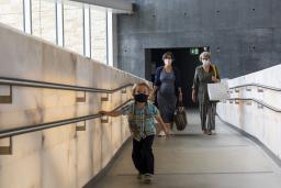 People walking up a ramp in the museum.