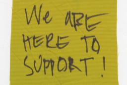 Piece of cloth with "We are here to support!"