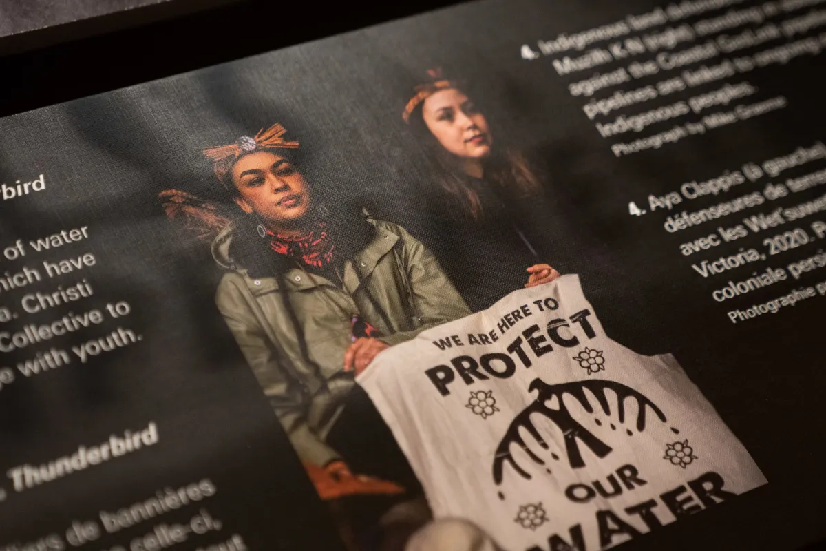 Aya Clappis et Madeline Muzilh K-N tenant une bannière sur laquelle on peut lire « We are here to protect our water ».