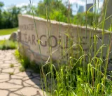Un mur décoratif en pierre sculptée avec le texte « Parc commémoratif Elzéar Goulet ».