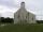 Image d’une église en bois à un seul clocher. Un panneau placé au-dessus des portes porte l’inscription « Seaview United Baptist Church ».