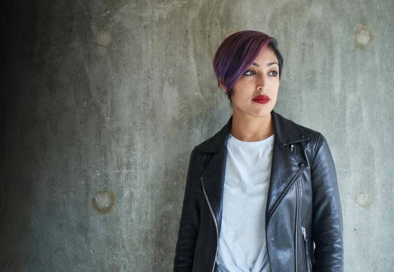 Une femme portant un manteau de cuir noir. Visibilité masquée.