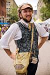 A man stares off camera with his hands on his hips.